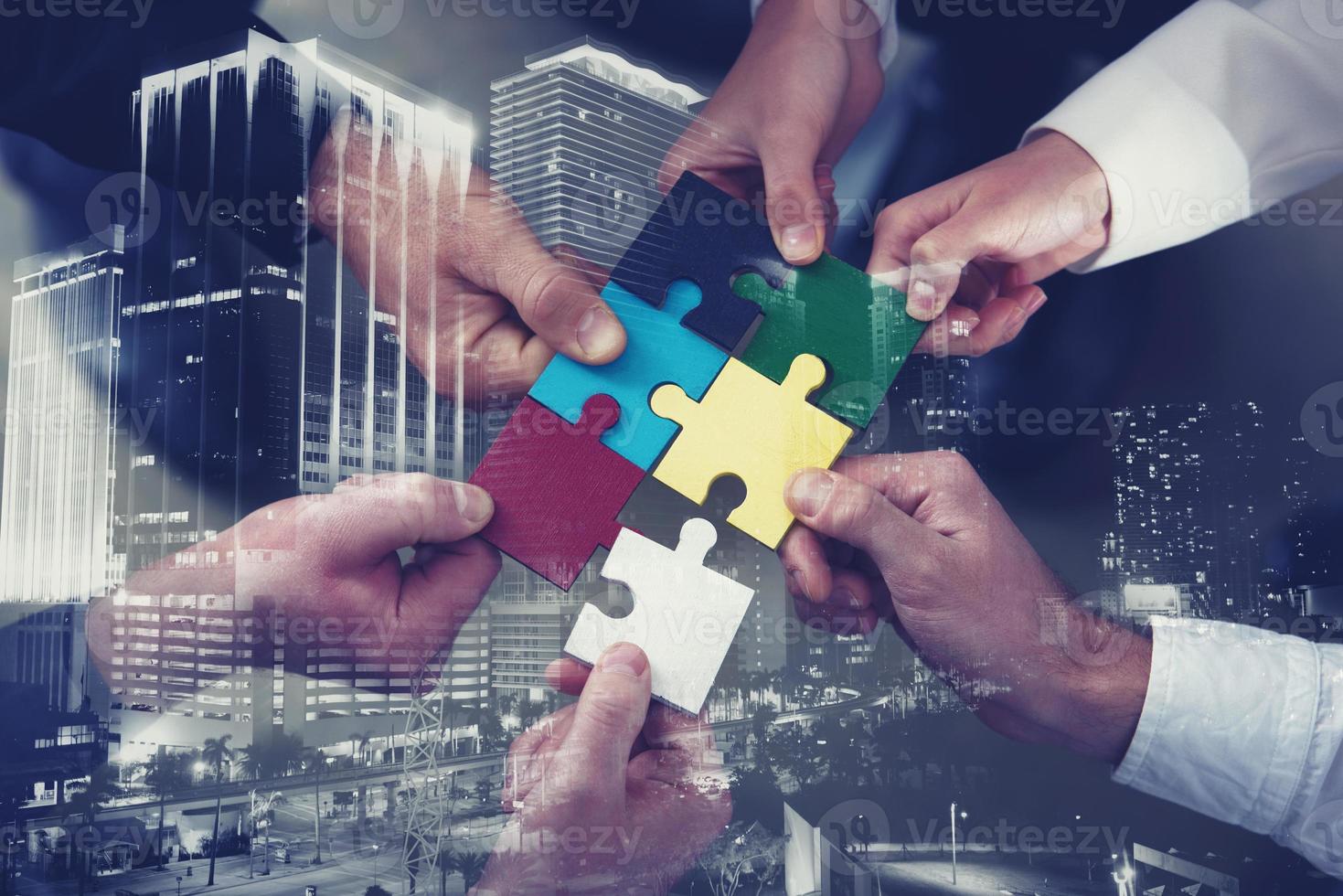 Teamwork of partners. Concept of integration and startup with puzzle pieces. double exposure photo