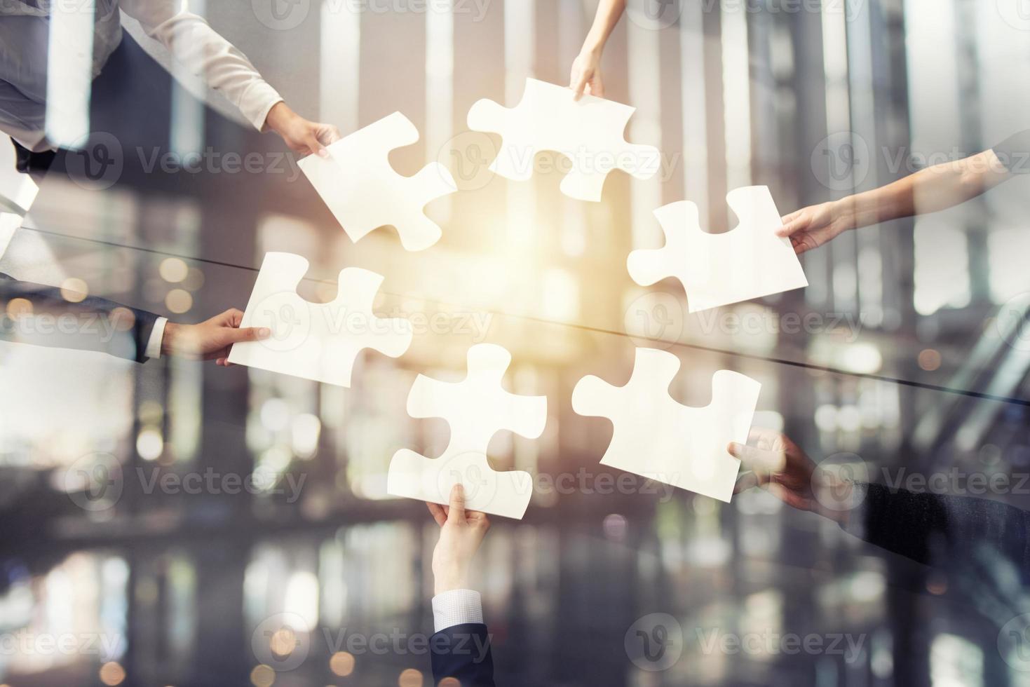 Teamwork of partners. Concept of integration and startup with puzzle pieces. Double exposure photo