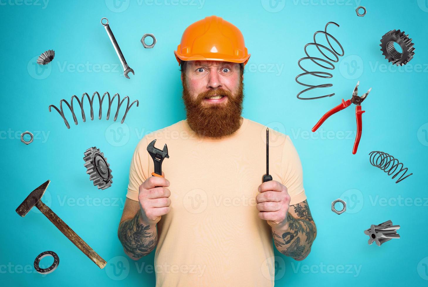Confused man with screwdriver and spanners. worried and uncertain expression. cyan background photo
