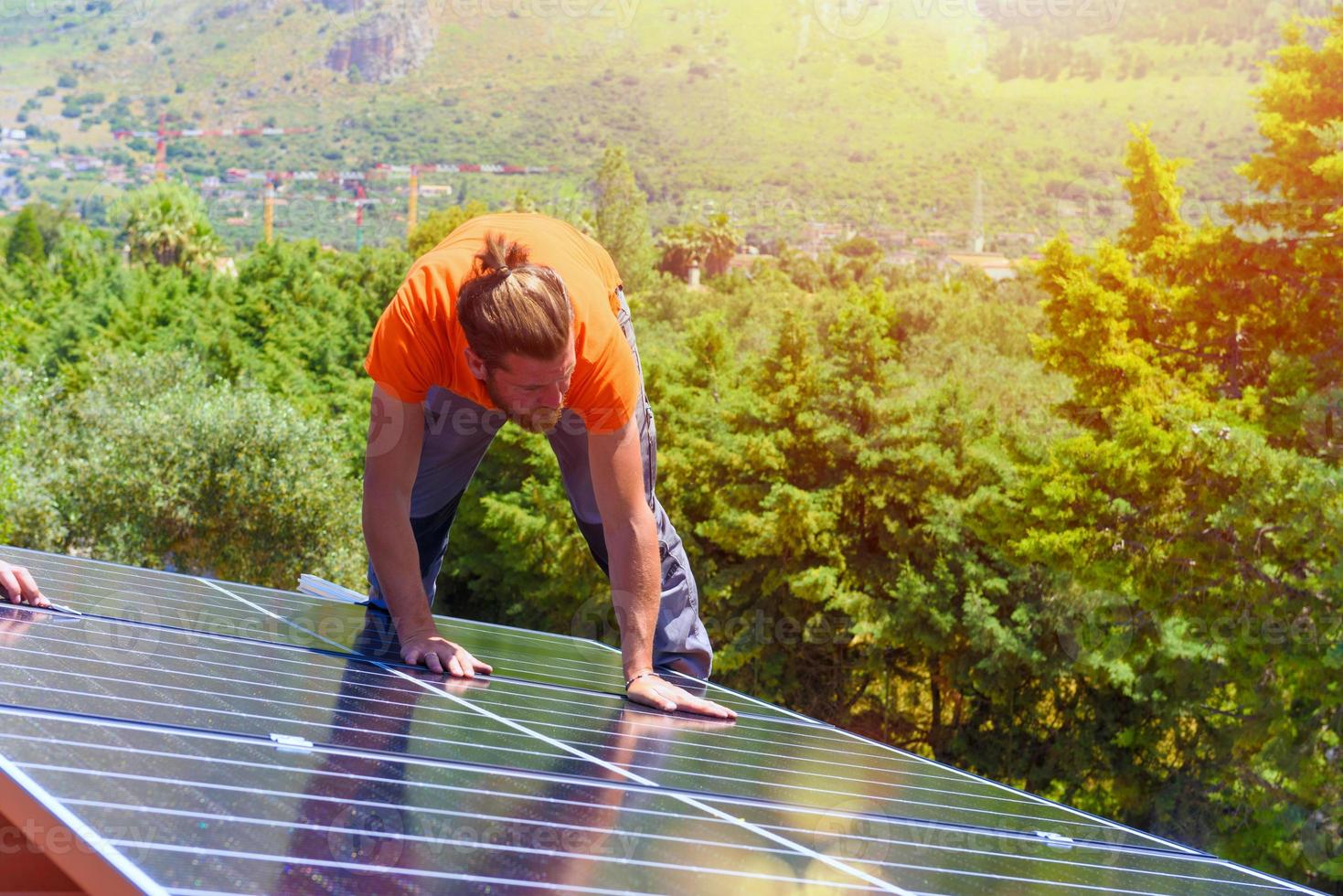 Workers assemble energy system with solar panel for electricity photo