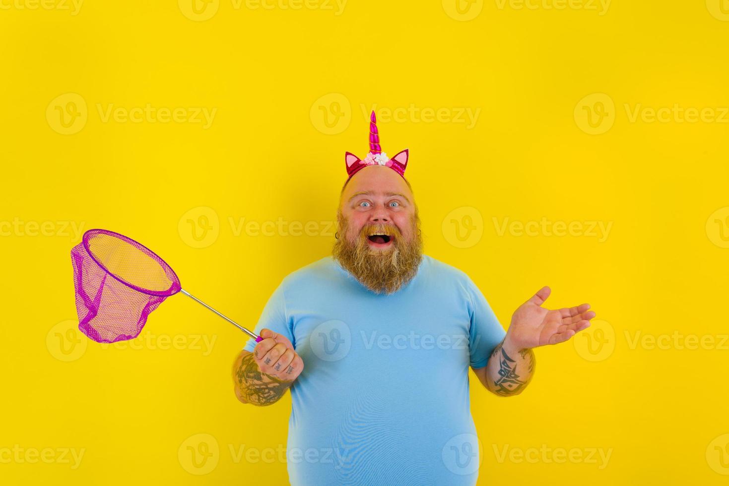 Fat thoughtful man with headband play with sea net photo