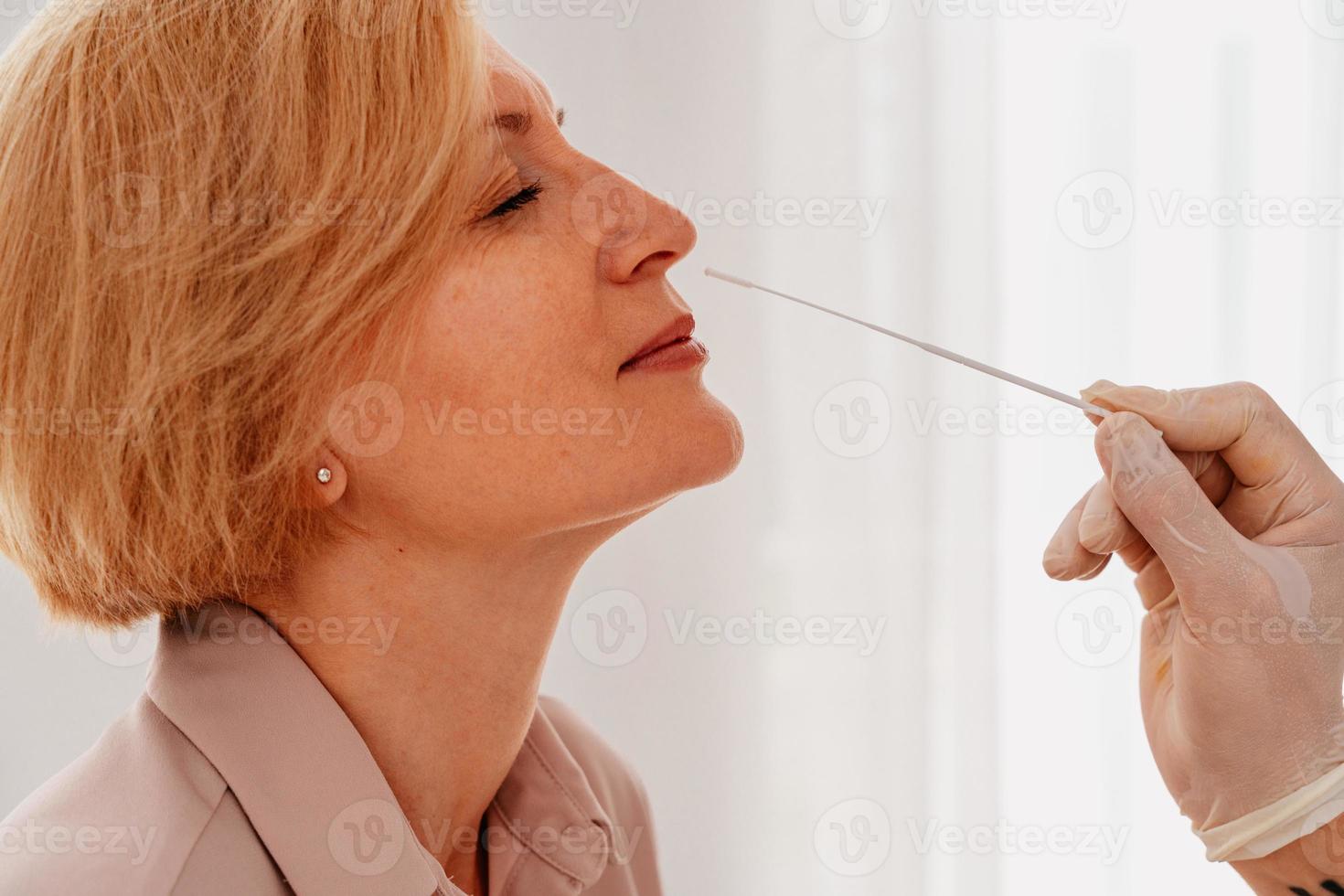 Doctor is checking the covid-19 virus with a tester photo