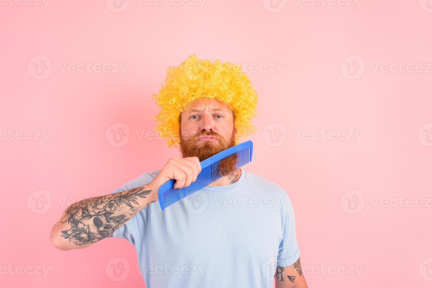 Thoughtful man with beard, yellow peruke and big comb photo