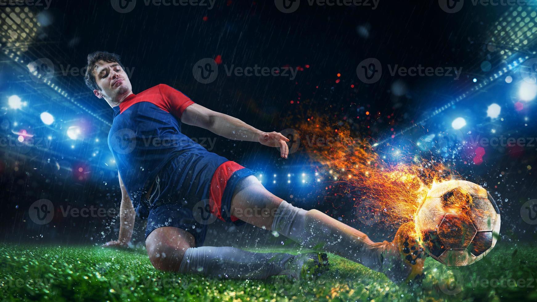 Powerful kick of a soccer player with fiery ball photo