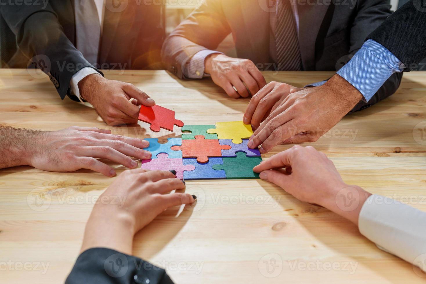 Teamwork of partners connect puzzle pieces as integration and startup photo