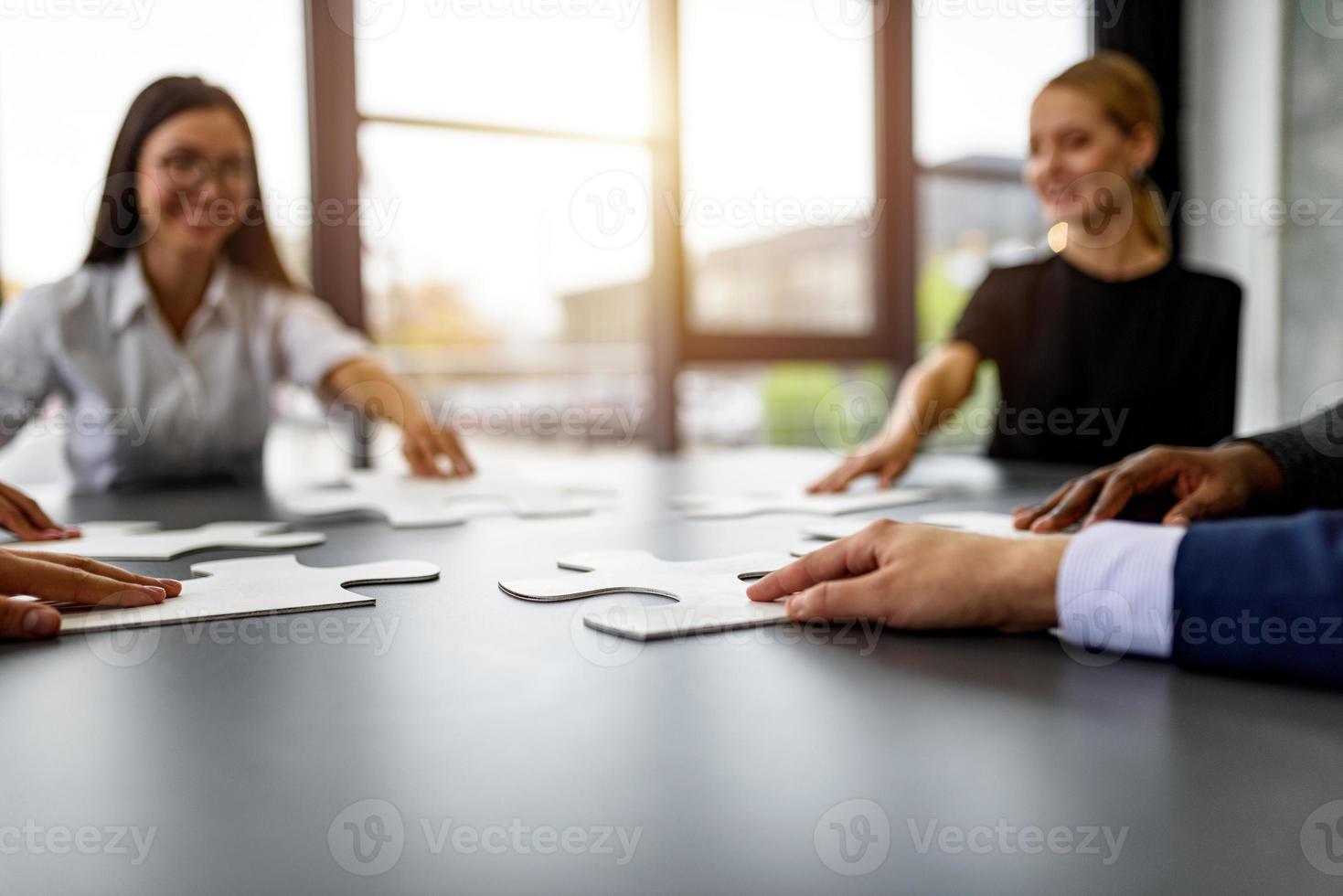 Teamwork of partners connect puzzle pieces as integration and startup photo