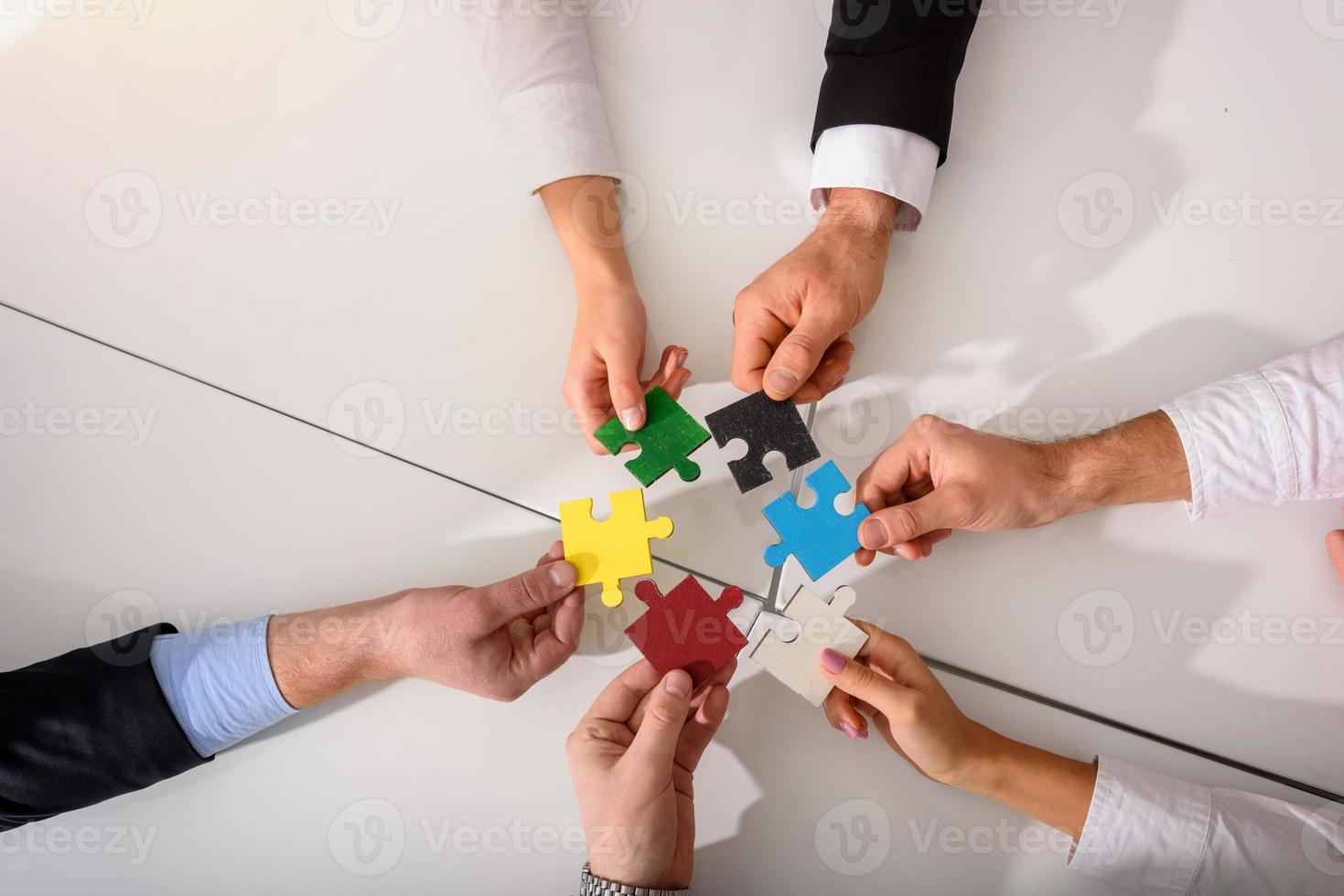 Teamwork of partners connect puzzle pieces as integration and startup photo