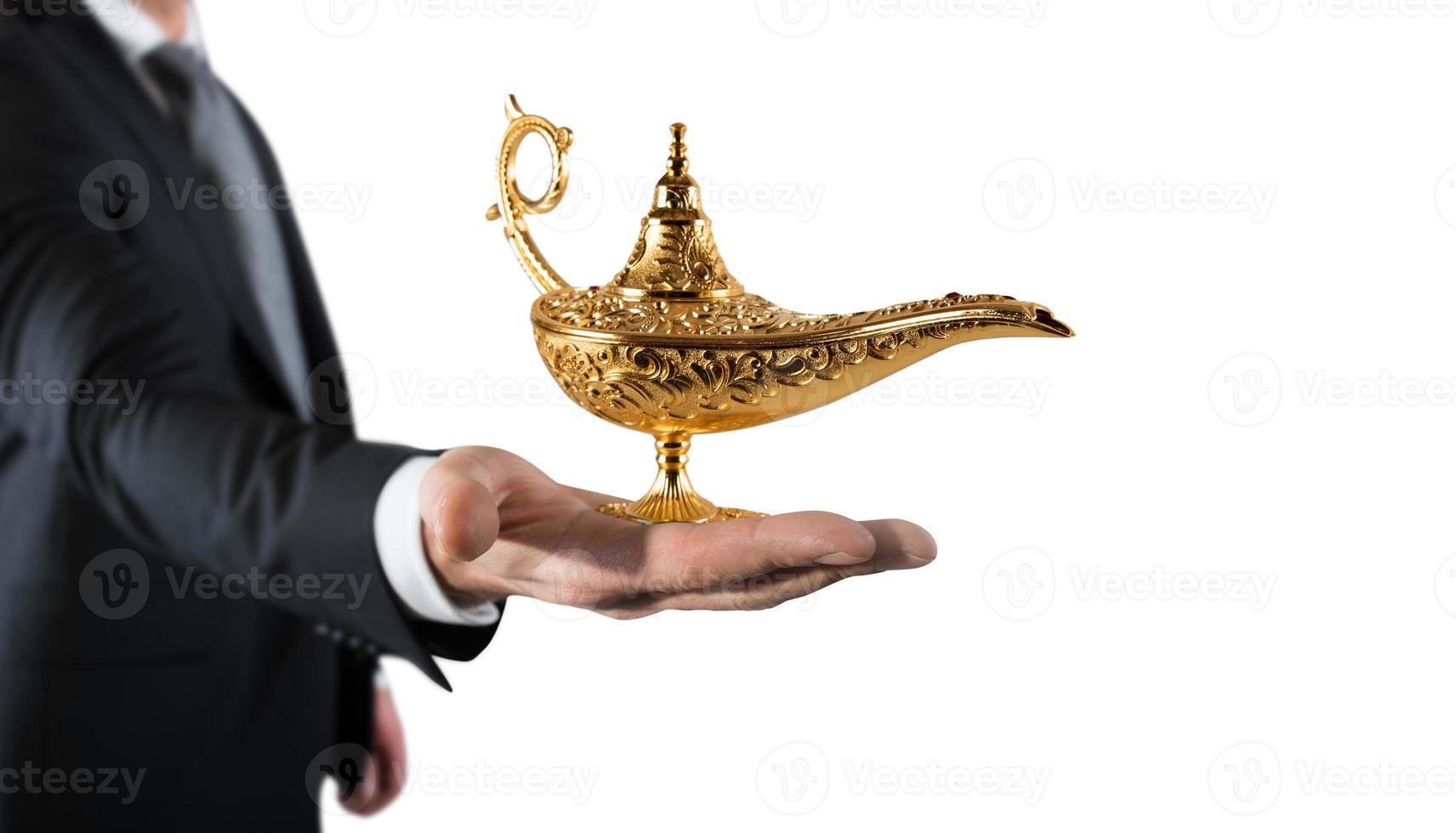 Businessman hold a genie lamp of aladdin. concept of desire and make a wish come true photo