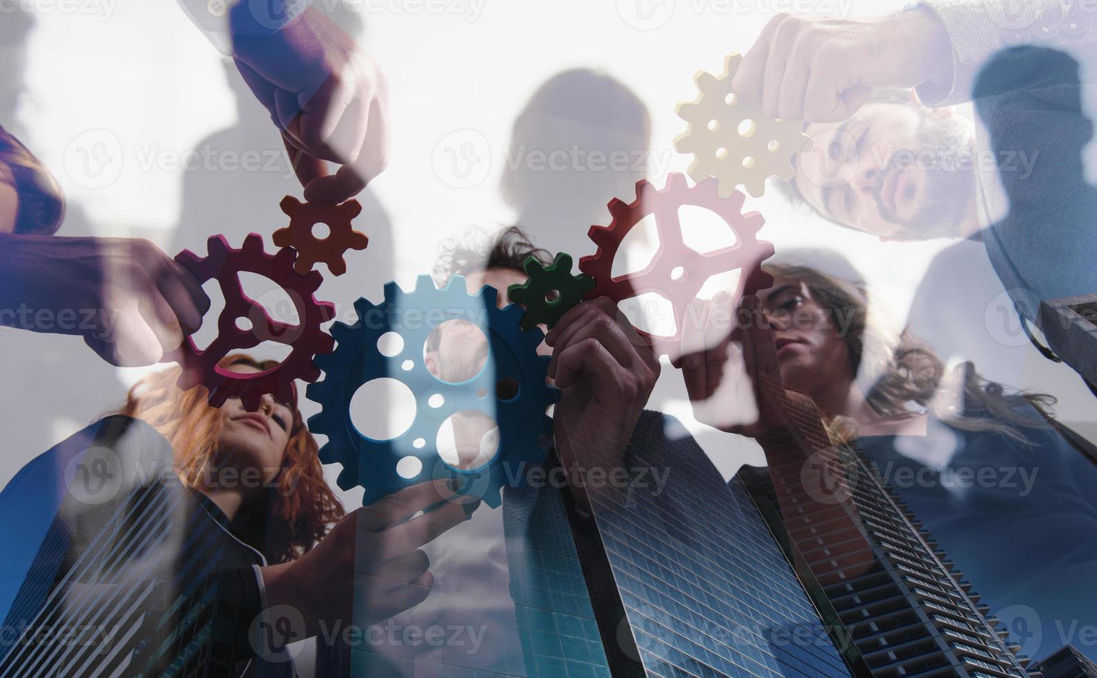 Business team connect pieces of gears. Teamwork, partnership and integration concept. double exposure photo