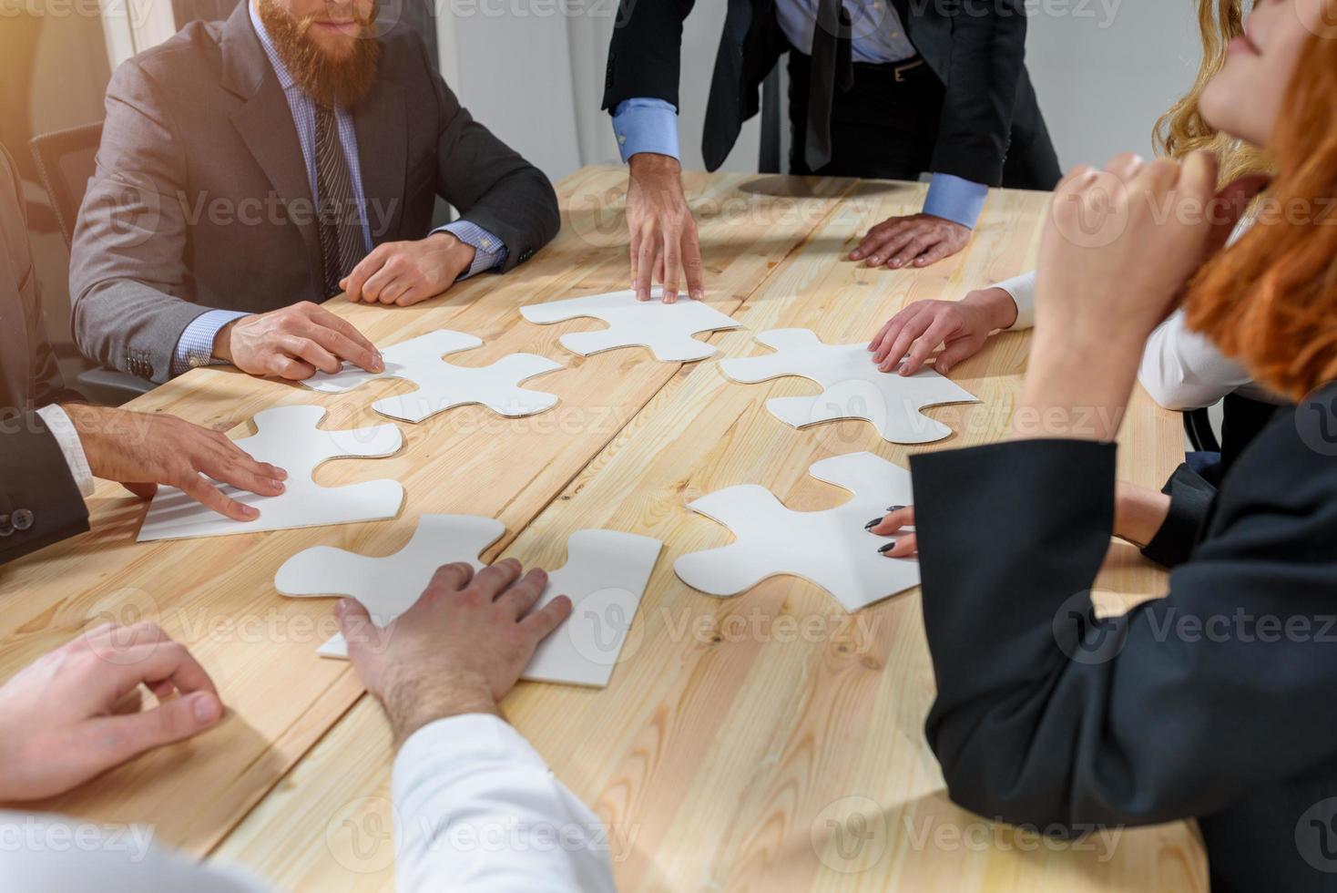 Teamwork of partners connect puzzle pieces as integration and startup photo