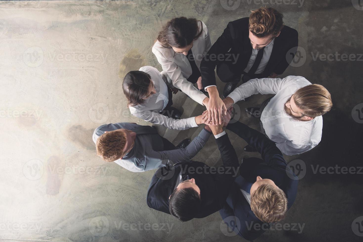 Business people putting their hands together. Concept of integration, teamwork and partnership photo