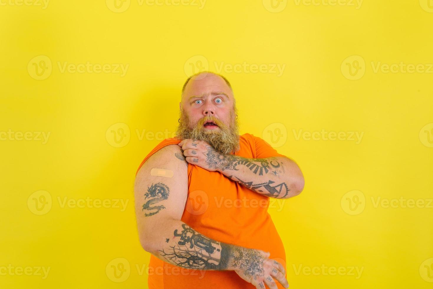 Amazed man with beard and tattoos did the vaccine against covid-19 photo