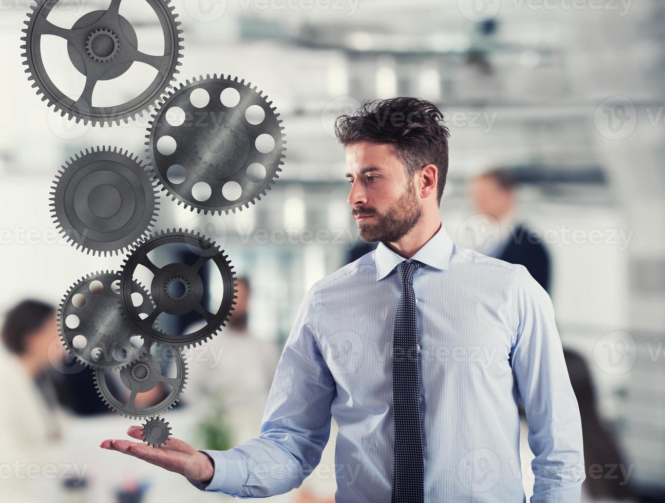 Businessman holds a gear system. Concept of business mechanism photo