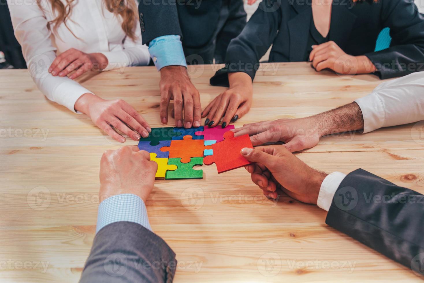 Teamwork of partners connect puzzle pieces as integration and startup photo