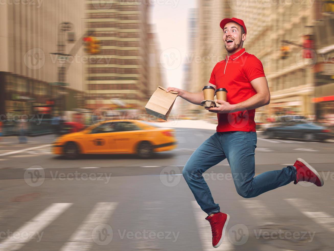 Delivery guy dressed in red runs to deliver the ordered drinks photo