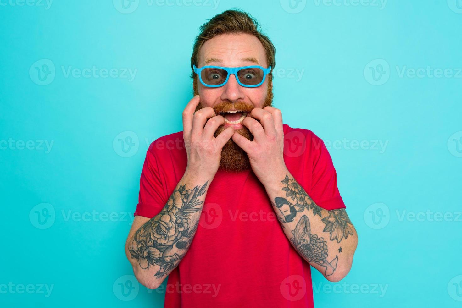 Man with beard and sunglasses is shocked and wondered photo
