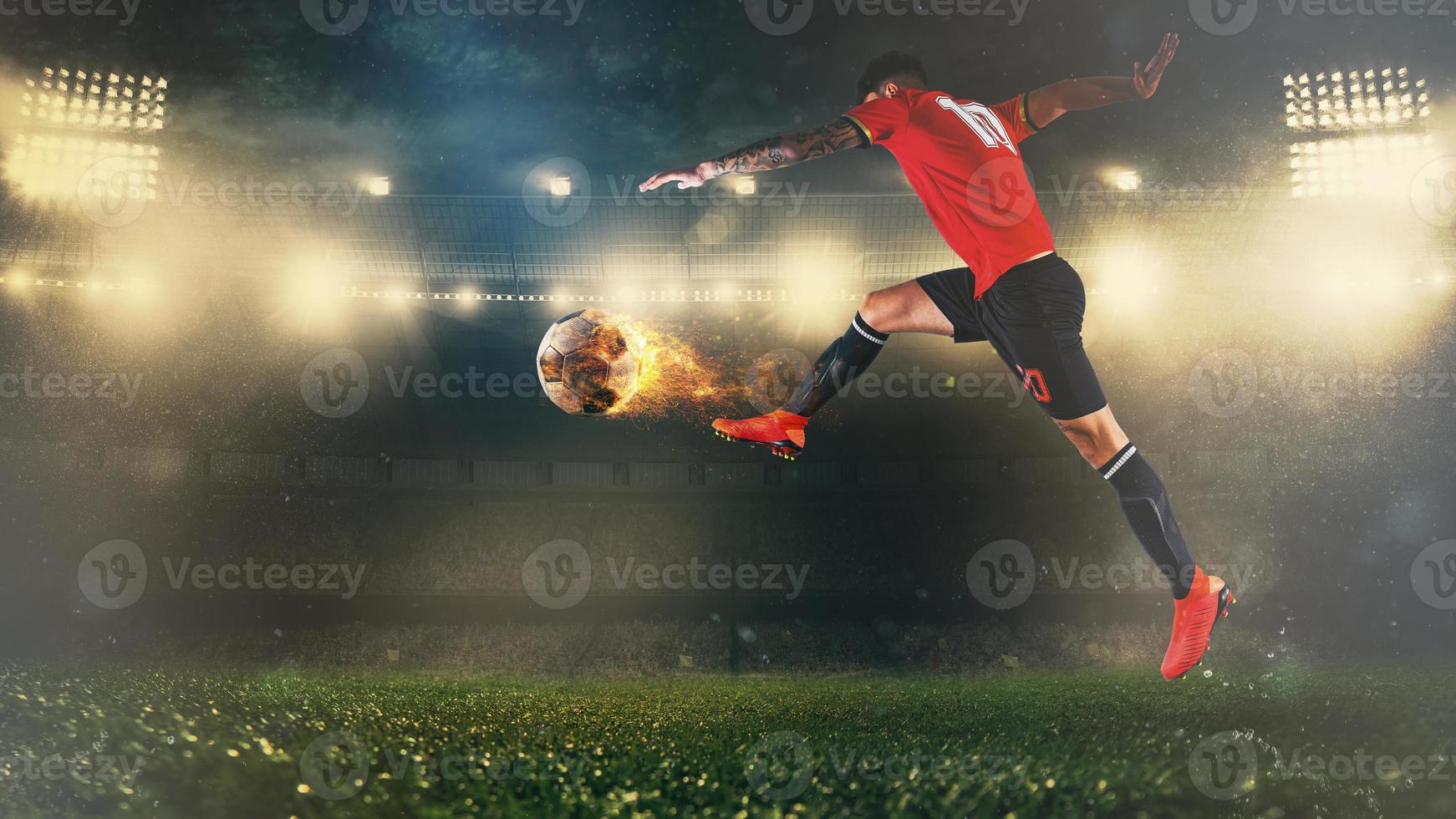 Soccer scene at night match with player in a red uniform kicking a fiery ball with power photo