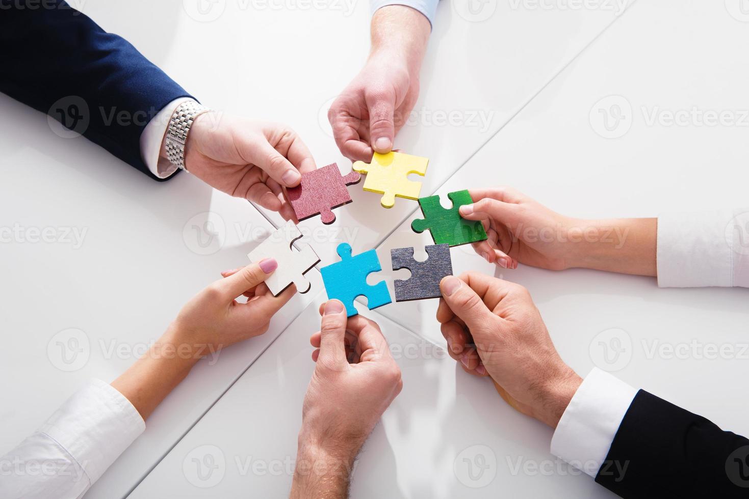 Teamwork of partners. Concept of integration and startup with puzzle pieces photo