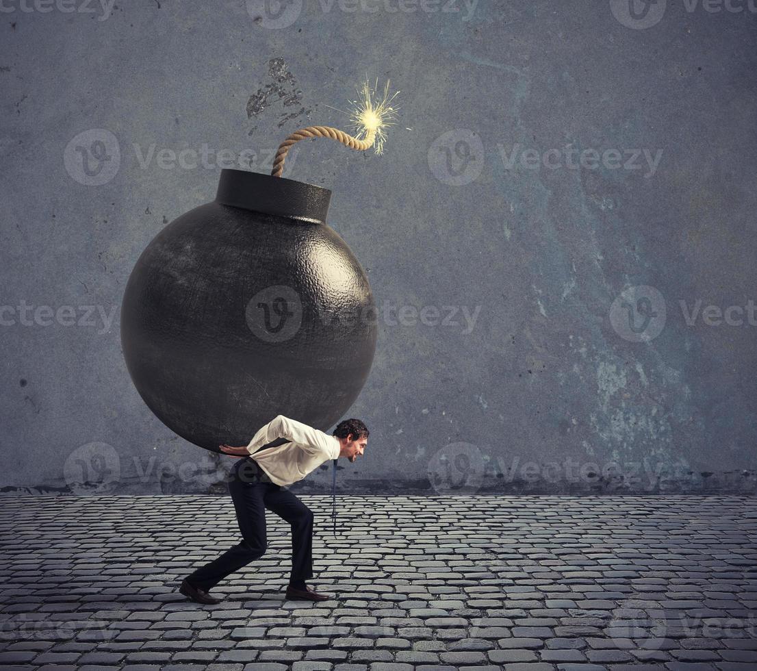 Businessman hold a bomb. Concept of difficult career and failure photo