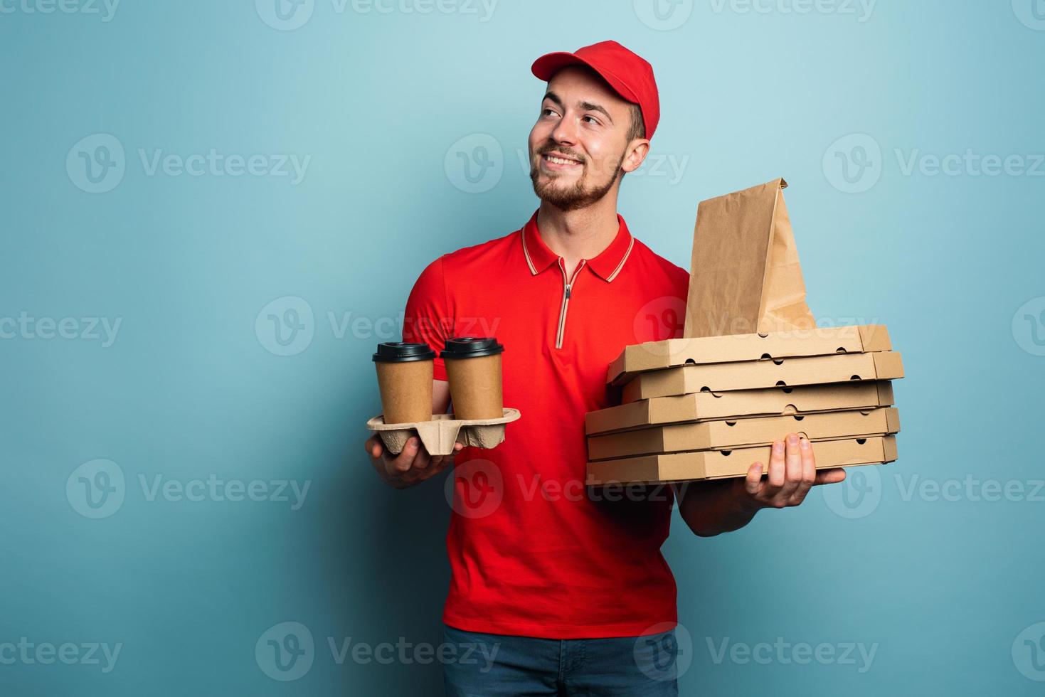 Courier is happy to deliver hot coffee,pizza and food. Cyan background photo