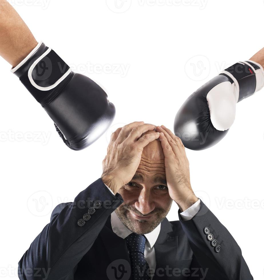 Businessman receives fists from competitors. concept of difficult career photo