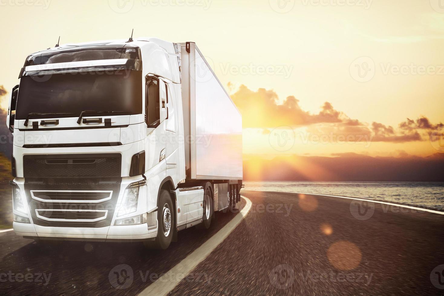blanco camión Moviente en el la carretera en un natural paisaje a puesta de sol foto