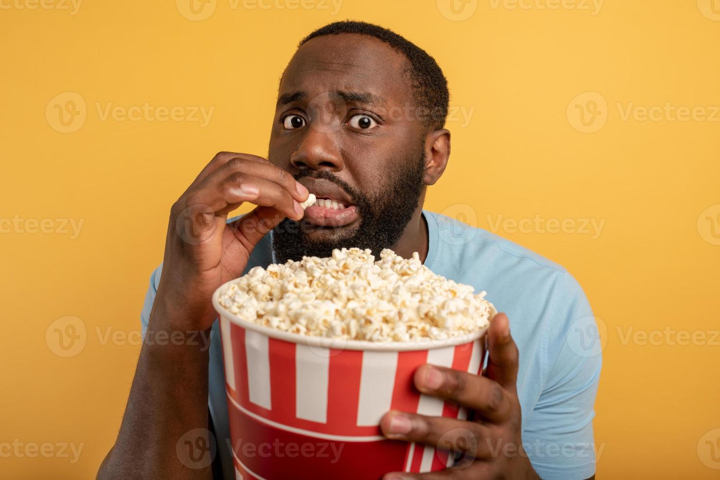 Worried boy watches a horror film. concept of entertainment and streaming tv. background photo