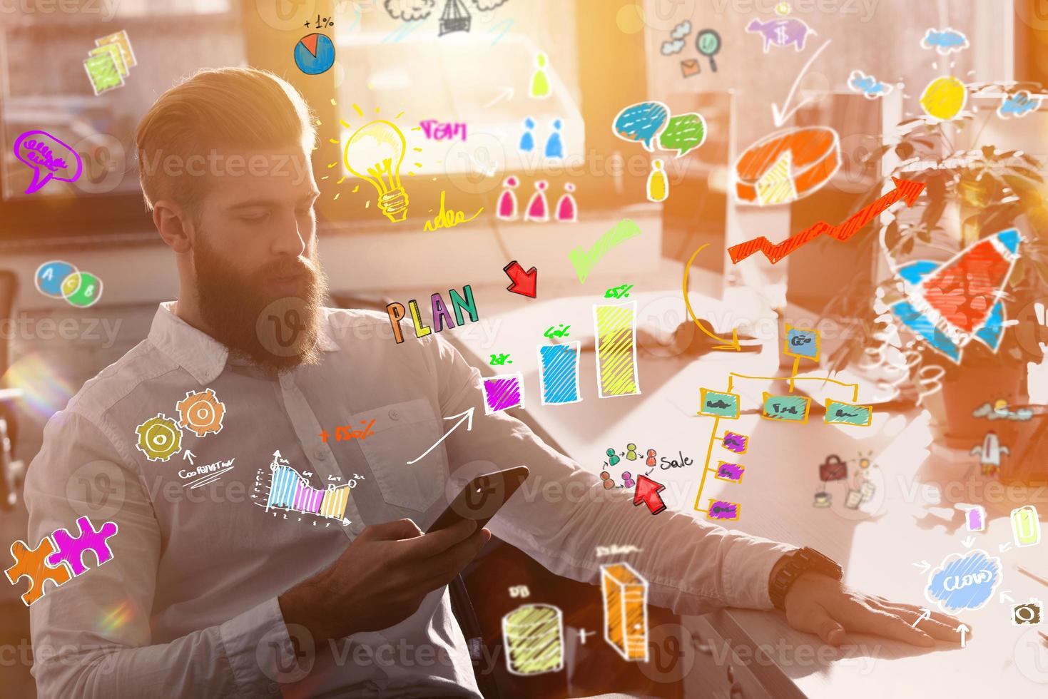 Businessman works in office with a smartphone on new projects photo