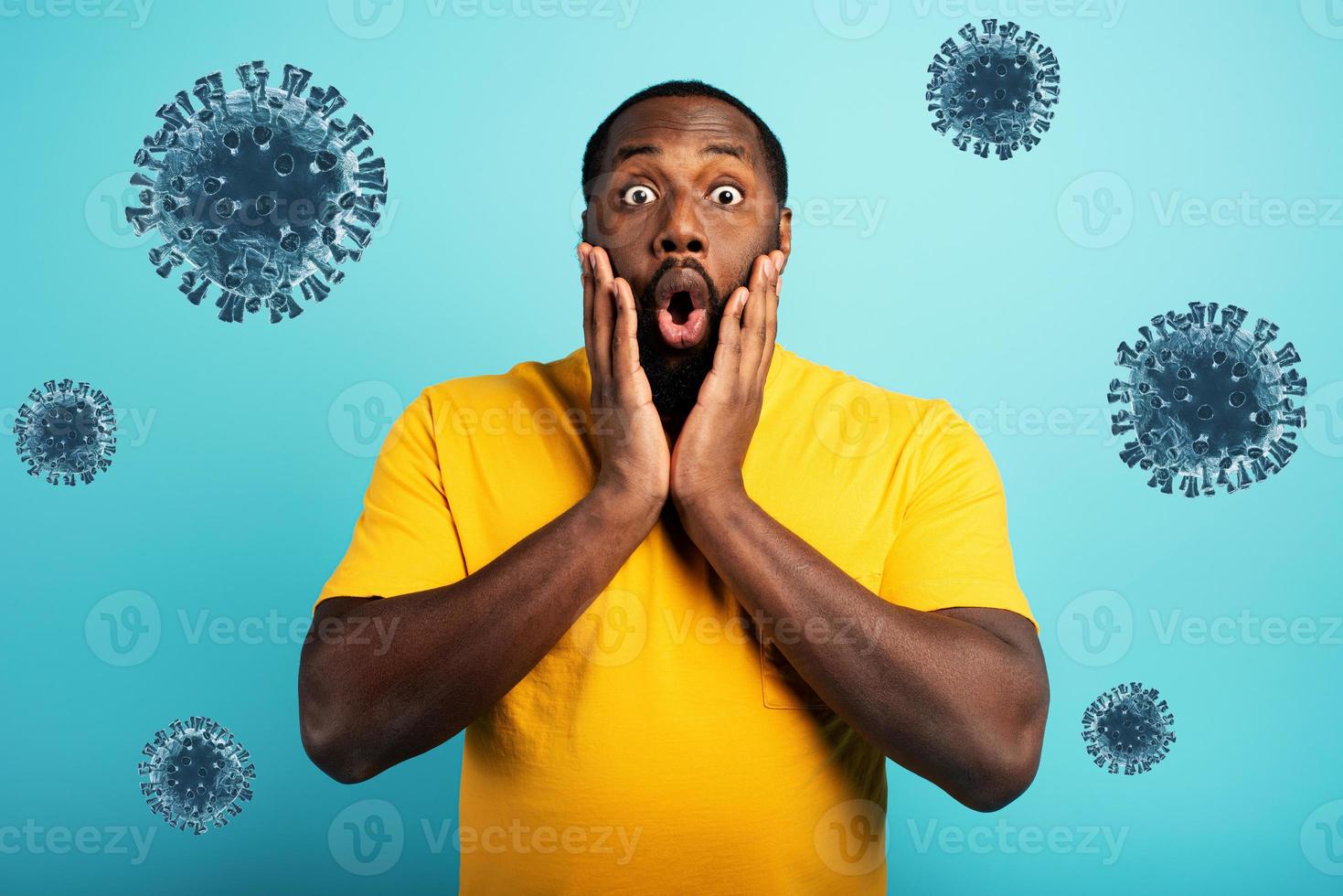 Fearful expression of a boy who is scared to catch the coronavirus. Cyan background. photo