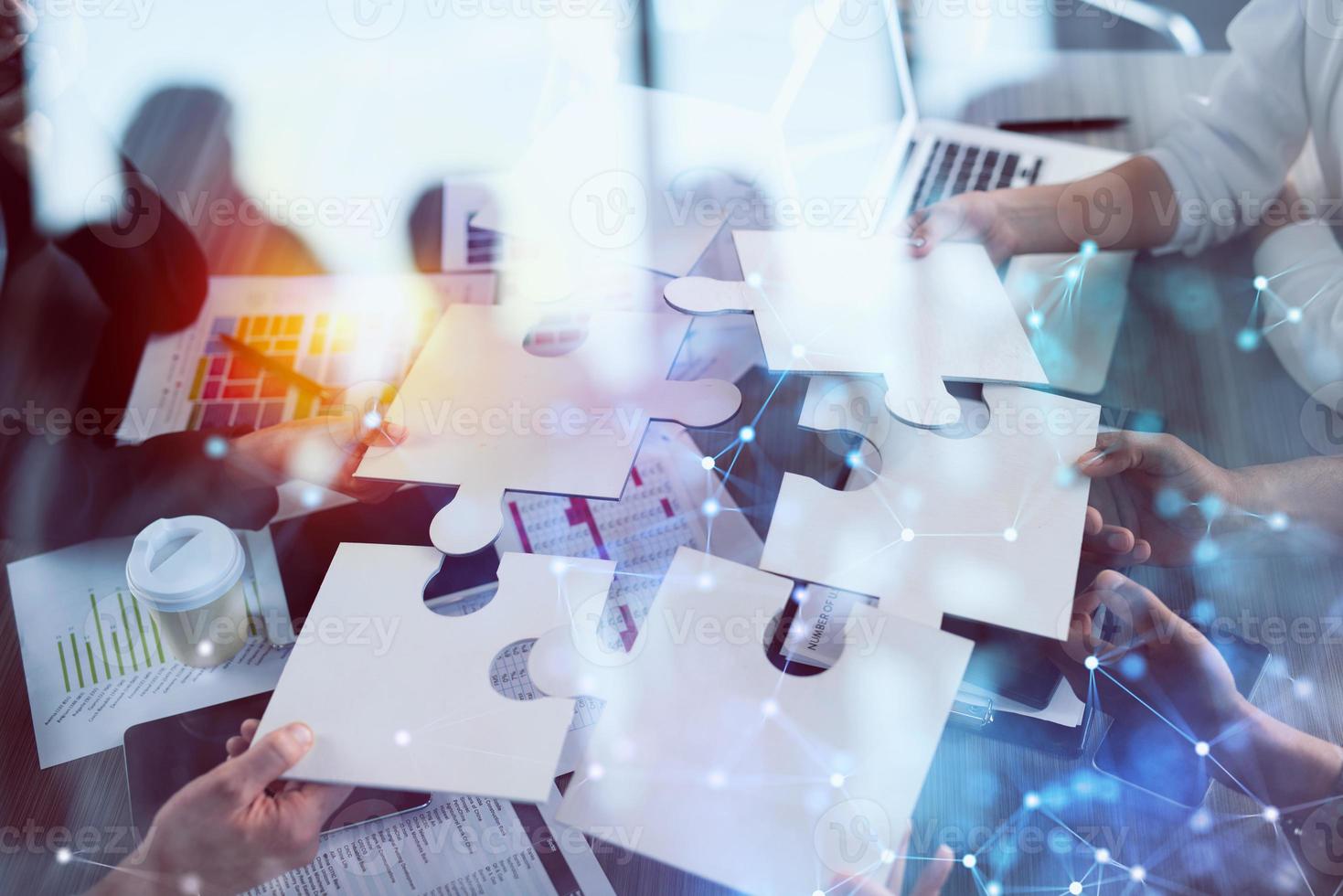 Teamwork of partners. Concept of integration and startup with puzzle pieces photo