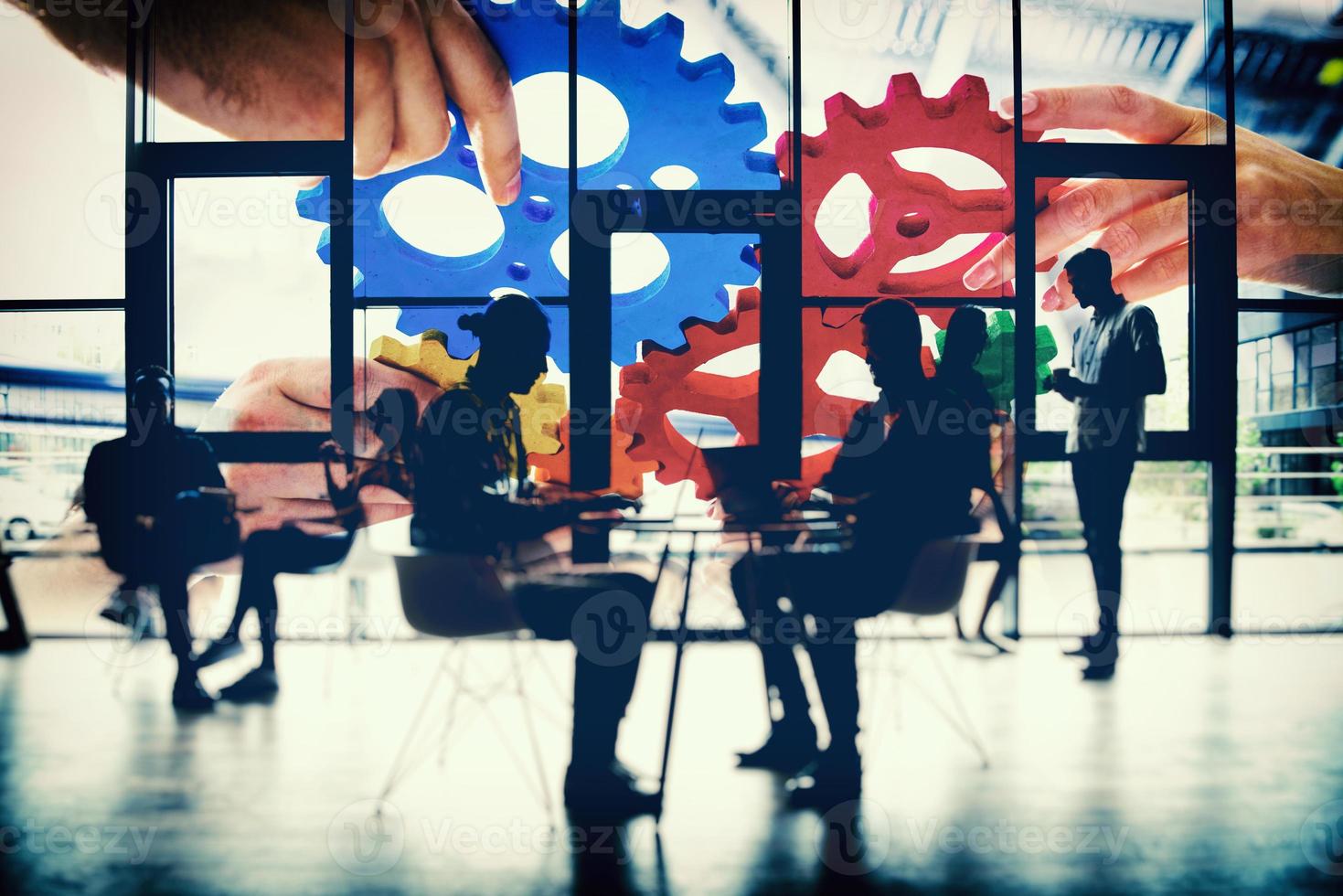 Business team connect pieces of gears. Teamwork, partnership and integration concept. double exposure with light effects photo