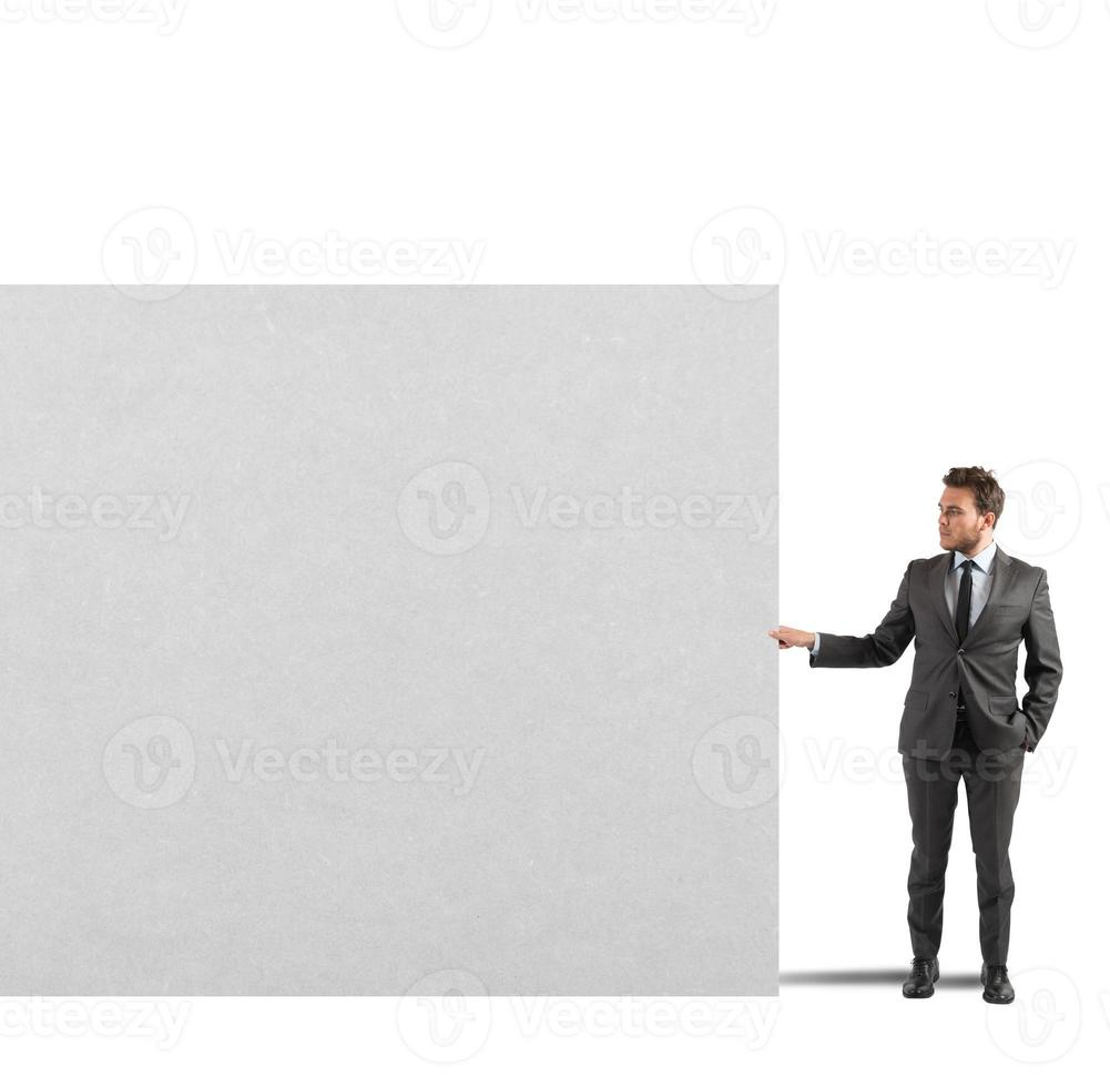 Businessman holds a blank billboard photo