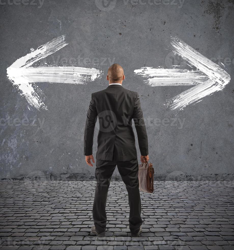 Confused businessman must choose the right way photo