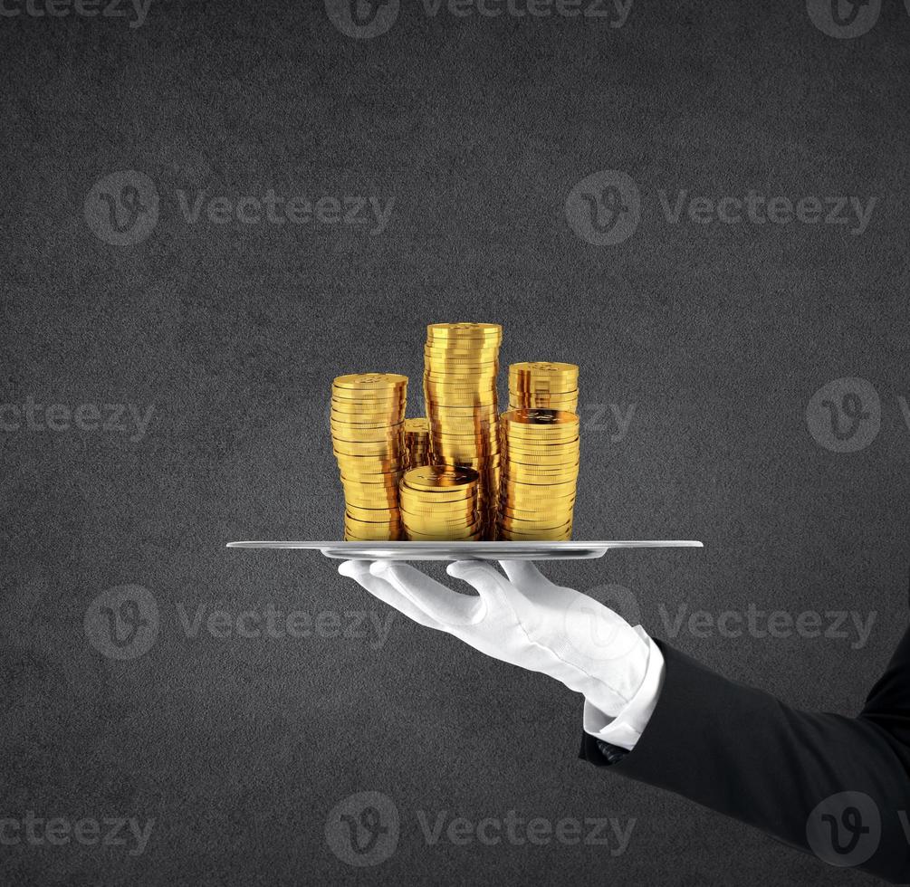 Waiter that holds a tray with golden coins. Concept of first class service on soccer photo