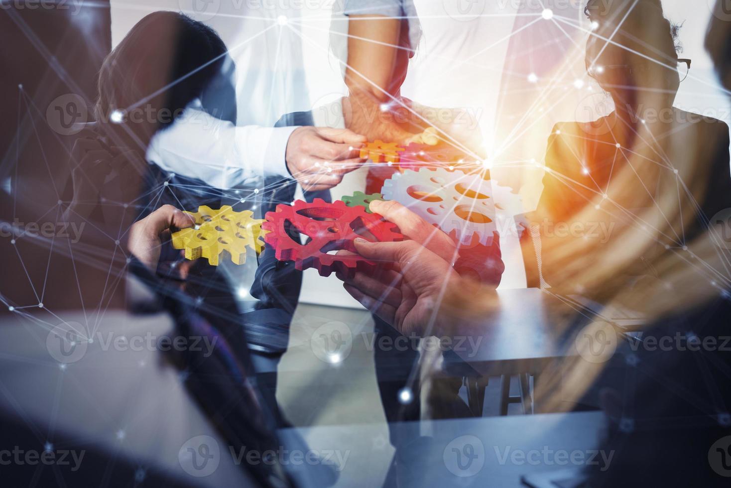 Business team connect pieces of gears. Teamwork, partnership and integration concept. double exposure with network effects photo