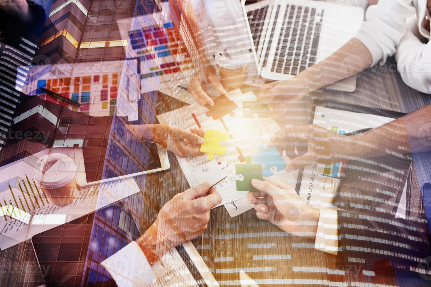 Business people join puzzle pieces in office. Concept of teamwork and partnership. double exposure with light effects photo