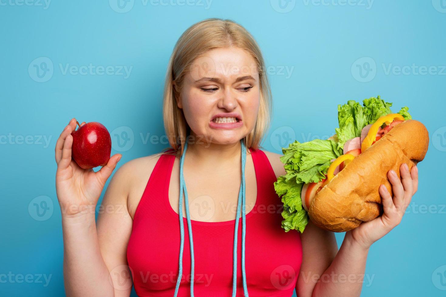 Fat girl does gym at home. thoughtful expression. Cyan background 20564946  Stock Photo at Vecteezy