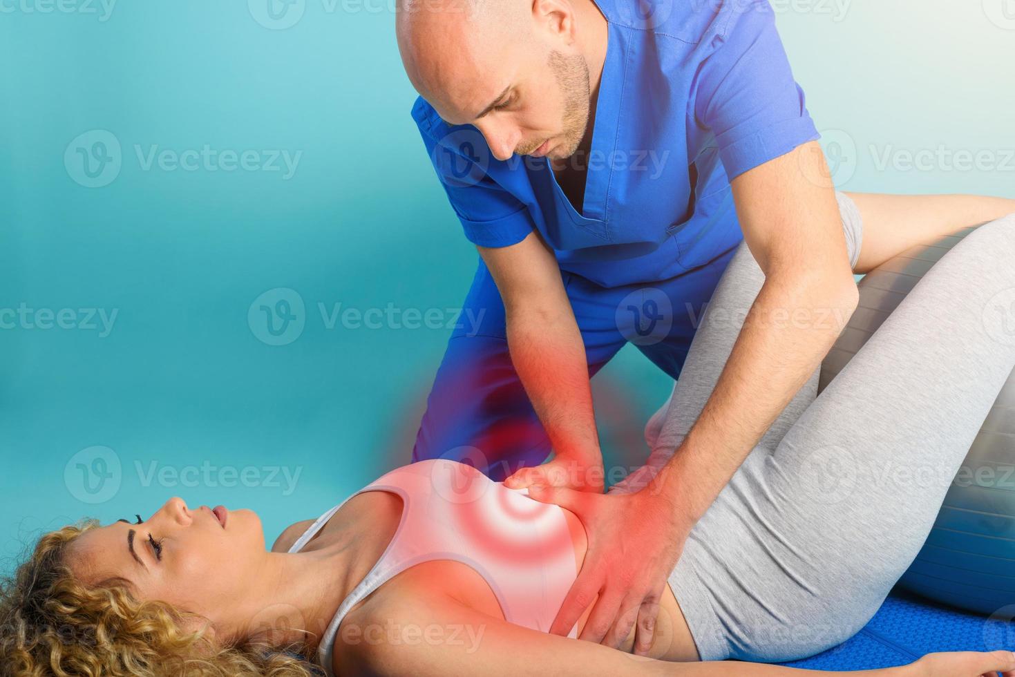 Girl performs exercises with a physiotherapist. Cyan background photo