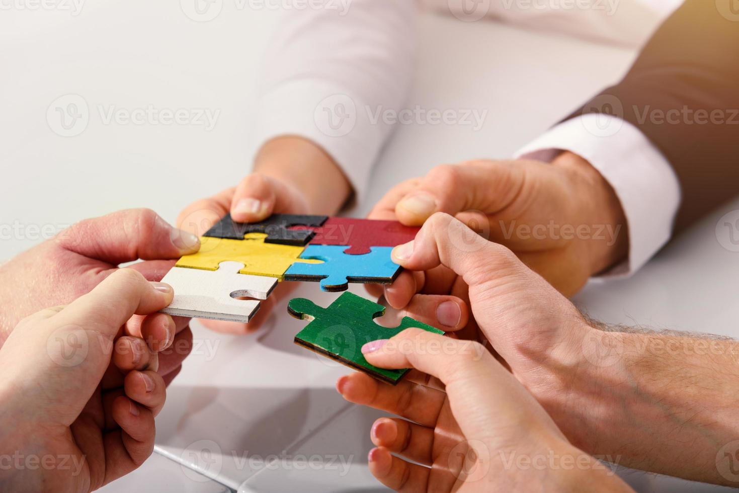 Teamwork of partners connect puzzle pieces as integration and startup photo