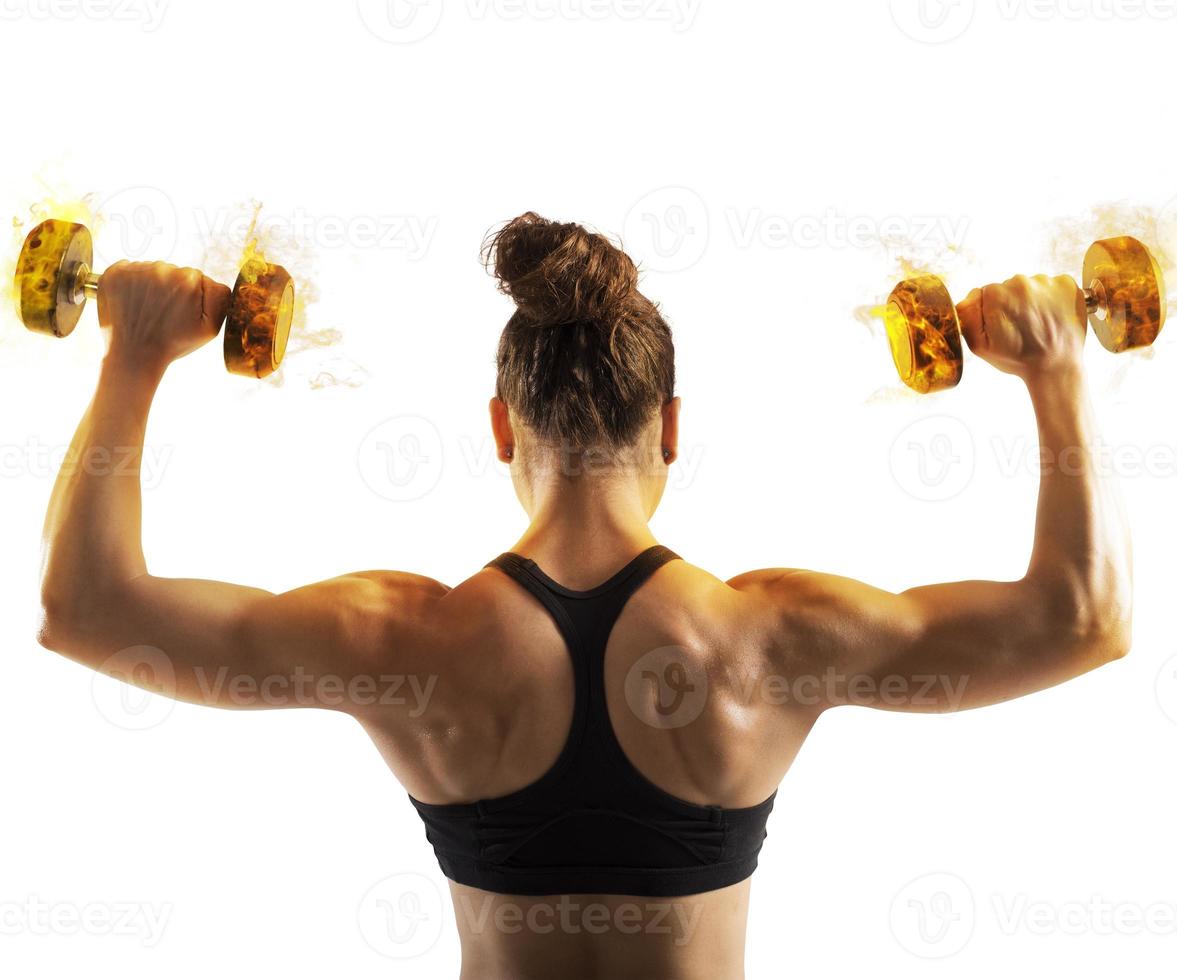 Woman training with fiery dumbbells photo