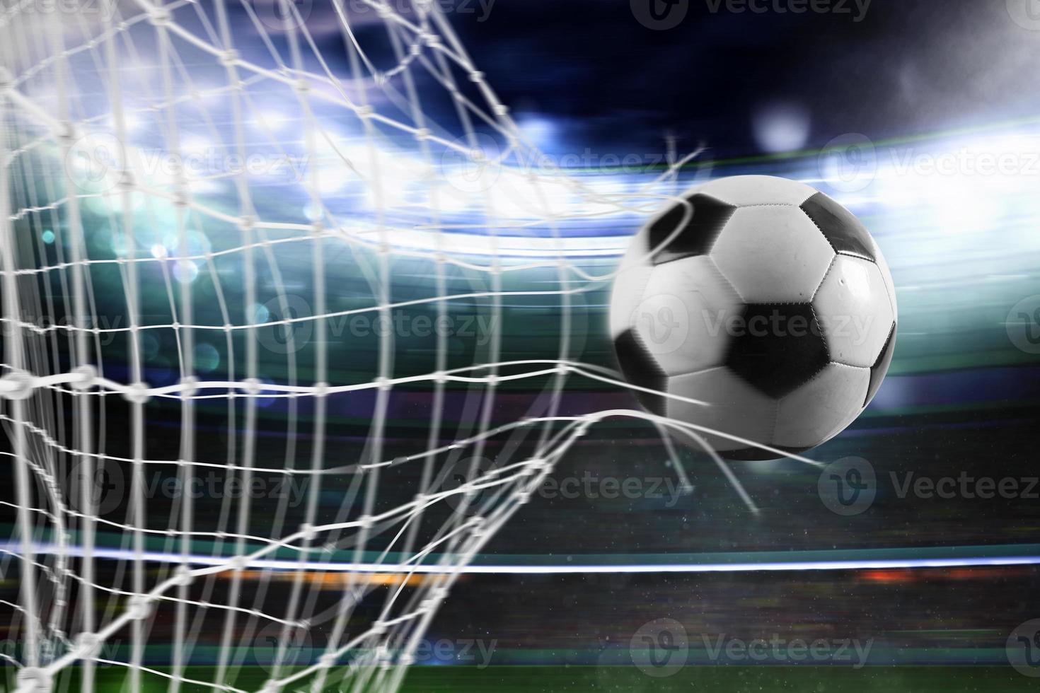 Soccer ball scores a goal on the net photo