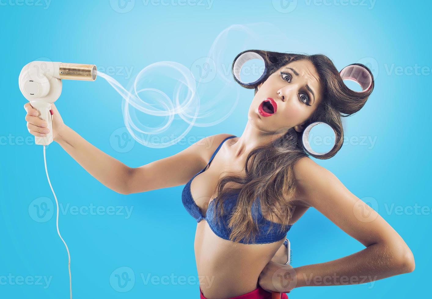 Brunette pin-up girl dries her long hair photo
