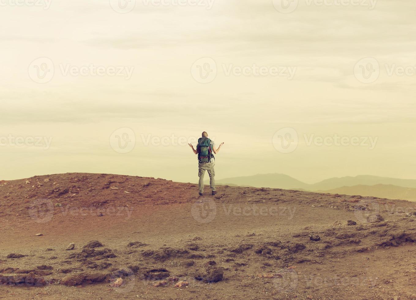 Uncertain explorer is lost in a desert. photo