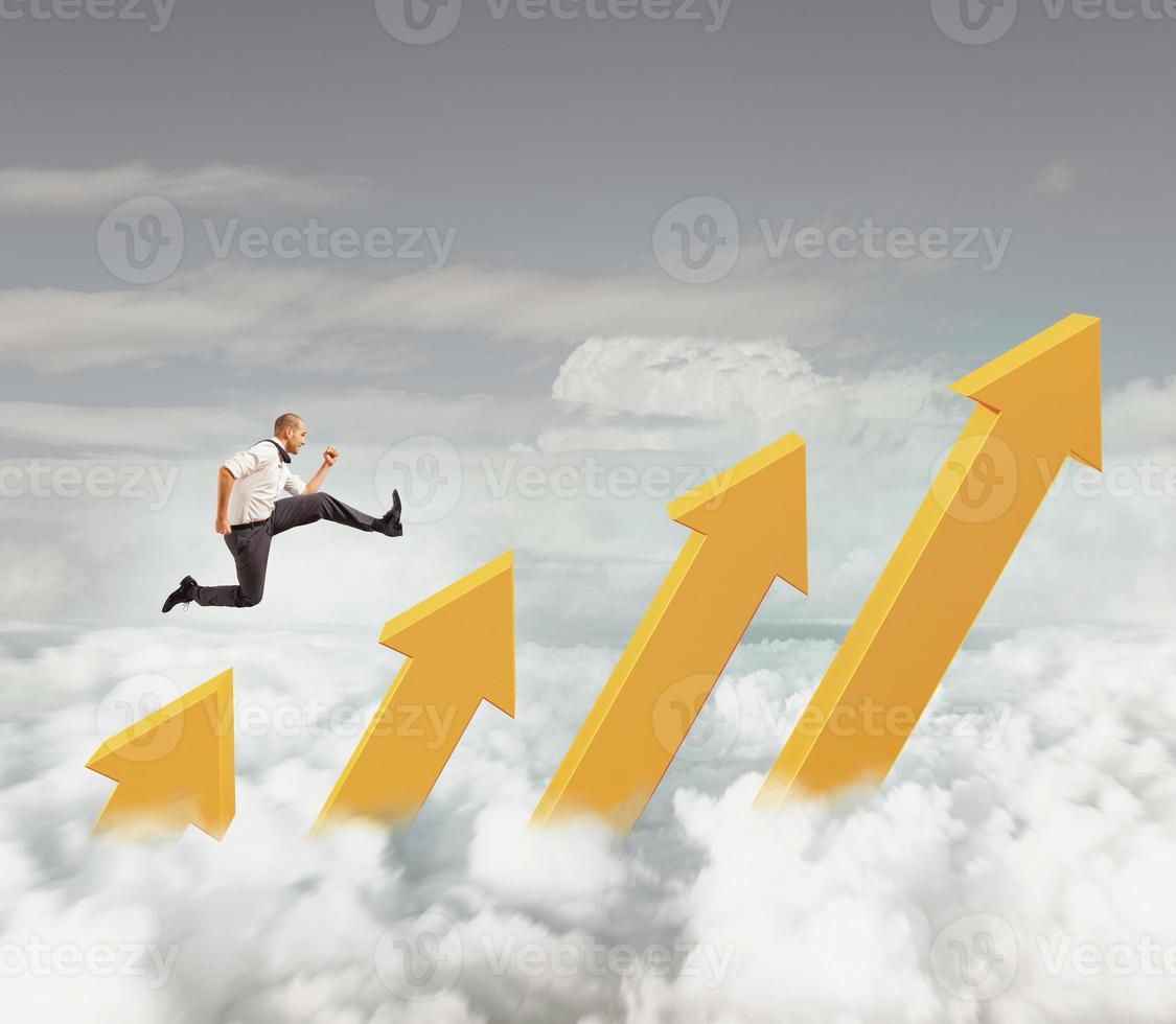 Businessman jumps on increasing statistic arrows to reach the top photo