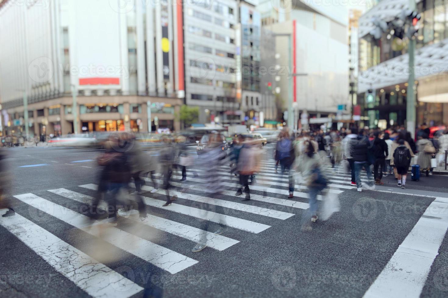 People walking in pedestrian crossing in Osaka photo