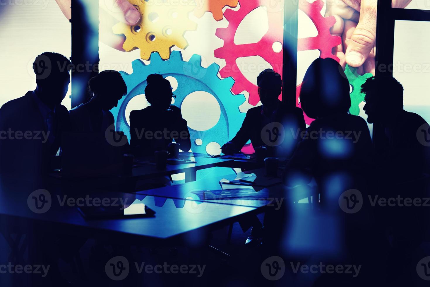 Business team connect pieces of gears. Teamwork, partnership and integration concept. double exposure with light effects photo