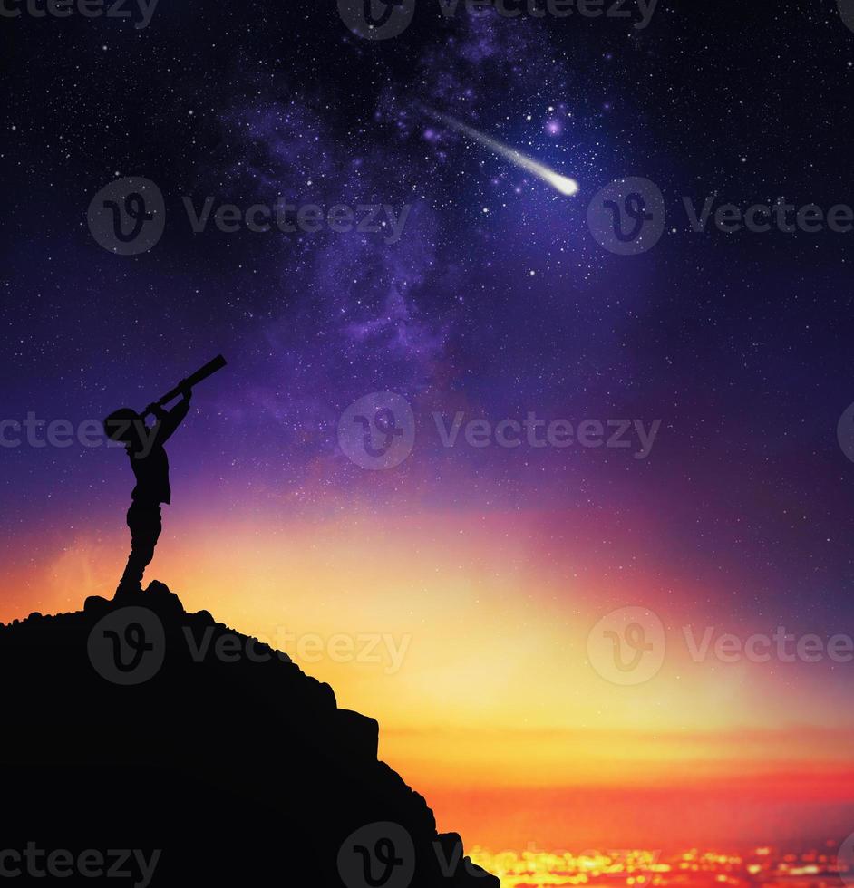 Child observes starry sky with a telescope photo