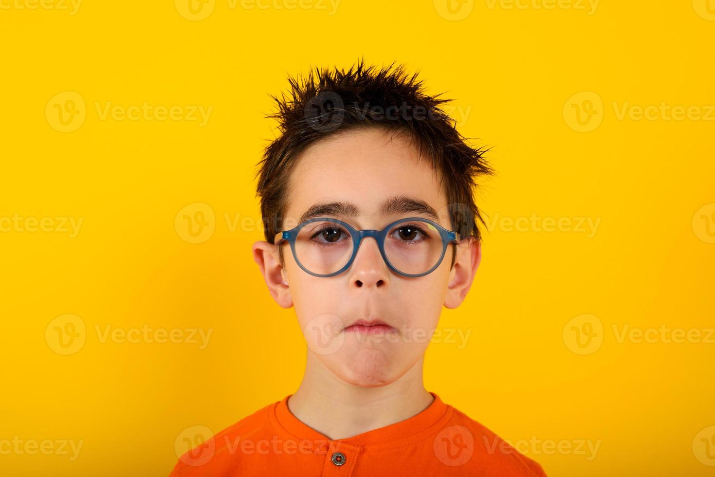 Child is not sure about something and has some questions. yellow background photo