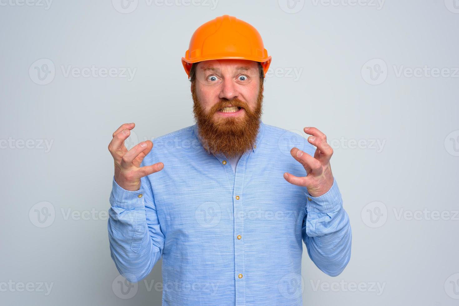 Isolated anger architect with beard and orange helmet photo