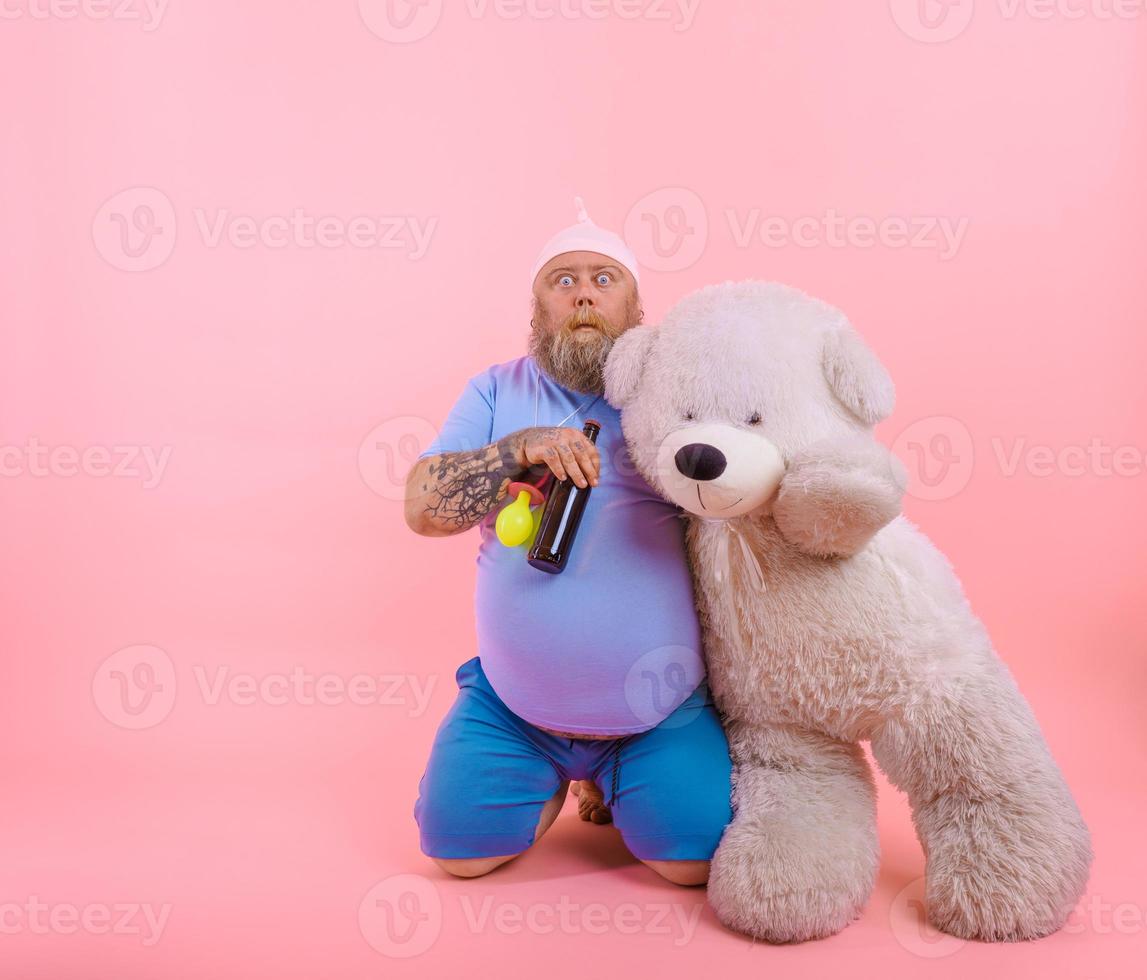 Fat amazed man acts like a amazed baby but drinks beer photo